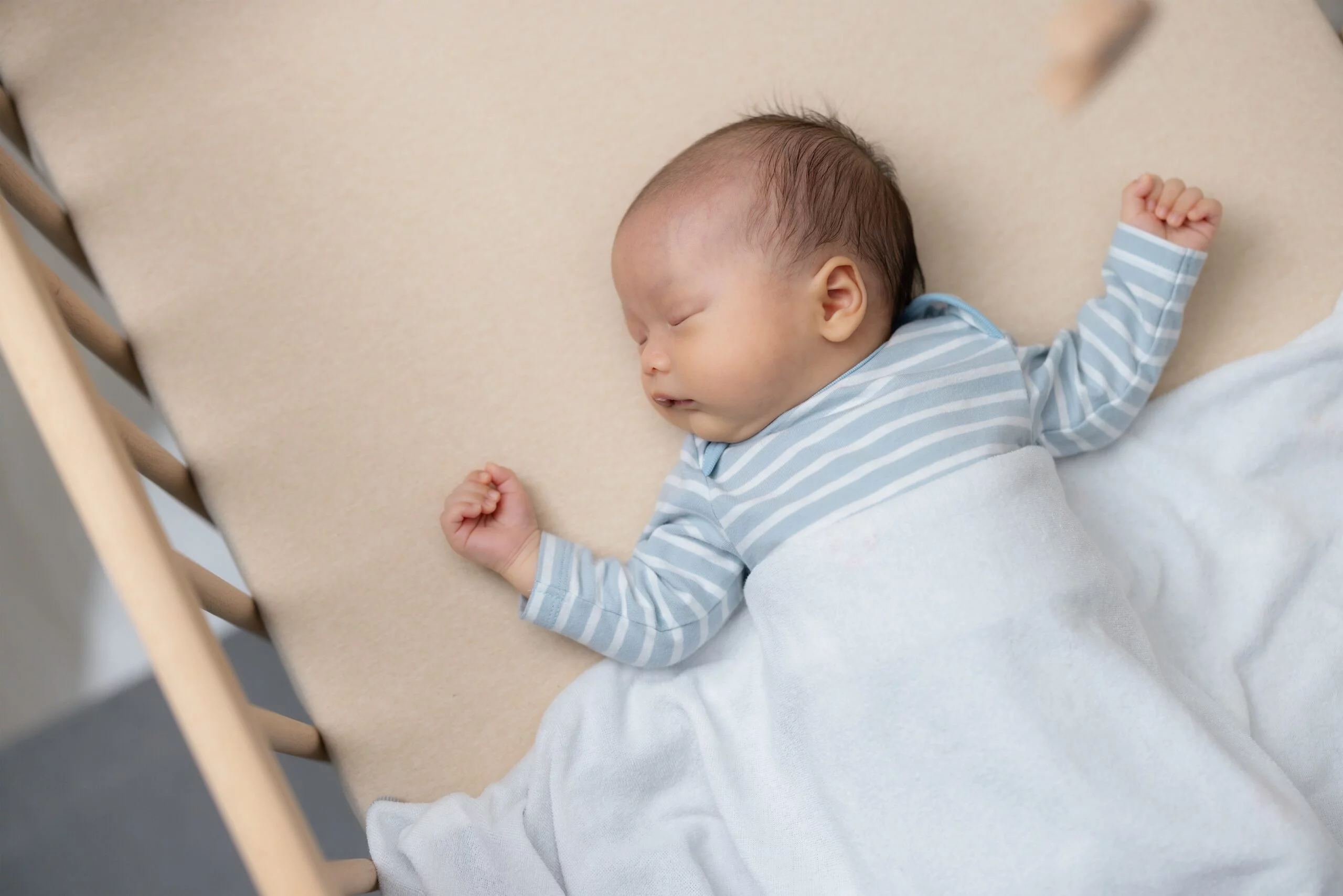 newborn sleeping in bassinet